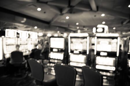 Filtered tone blurry background typical casino in America with slot machines and themed gameの写真素材