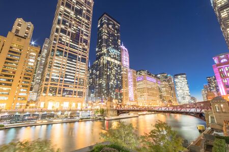Stunning view of riverside Chicago skylines at blue hour toward Clark Street
