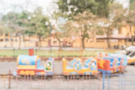 Blurred background playground near apartment building in Hanoi, Vietnam. Colorful amusement style urban recreation with train ride and seesaw.の写真素材