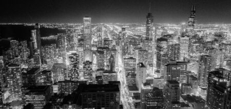 Black and white filtered image of downtown Chicago illuminated skylines at evening. Aerial view beautiful Chicago cityscape from observation desk.の写真素材