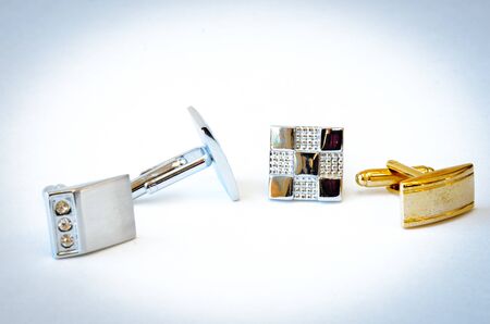 Studio shot group of modern stainless steel cufflinks isolated on white