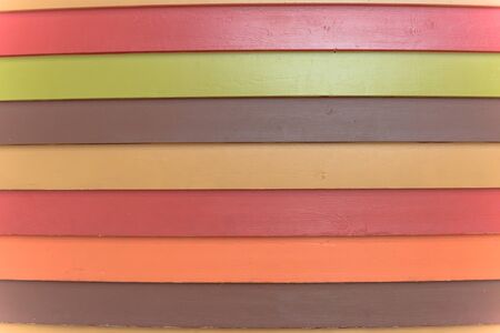 Rainbow color vinyl wooden siding panel background with imitation wood texture. House wood wall...
