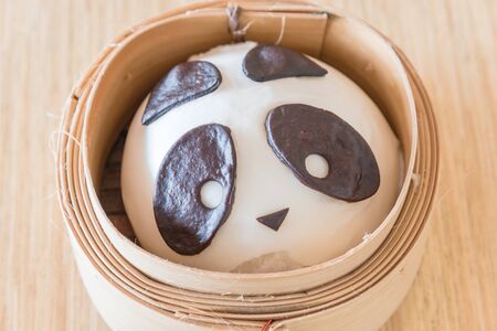 Close-up top view traditional Chinese animal-shaped mantou buns of pandas on mini bamboo steamer. Tasty panda bear dumpling steamed bunsの写真素材