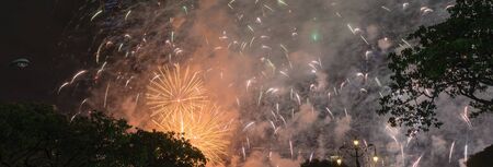 Panorama beautiful firework display at New Year Eve celebration in Singapore. Colorful festive background.の写真素材