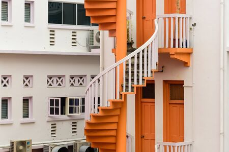 Close-up colorful spiral staircases at the back of traditional Chinese shop houses in Bugis Village, Singapore.の写真素材