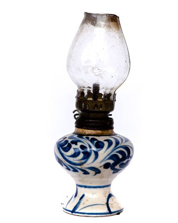 Old burning vintage Vietnamese oil lamp isolated on white background. It is the primary source to light up at home and community activities in past few decadesの写真素材