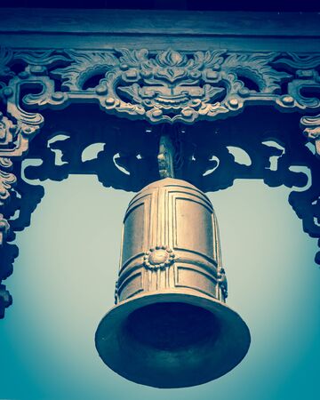 Typical bell tower outdoor instrument, ancient bell and gazebo in the pagoda in Vietnamの写真素材