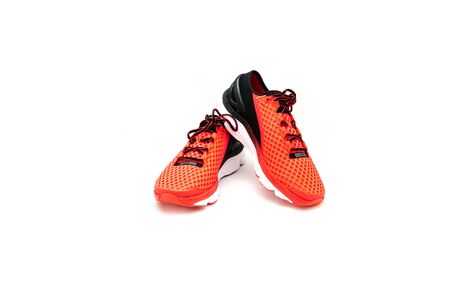 Close-up, top view a pair of brightly red running shoes isolated on white background. New unbranded running shoes, sneaker or training with clipping path and copy space. Active and healthy lifestyle.の写真素材