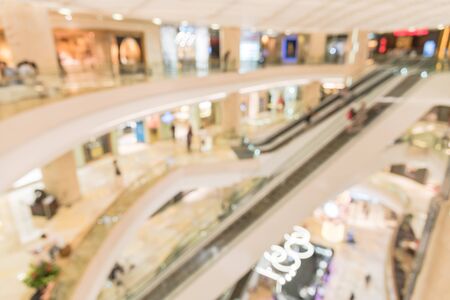 Abstract blurred multilevel structure of elevator and escalator in modern shopping mall in Singaporeの写真素材