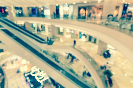 Abstract blurred multilevel structure of elevator and escalator in modern shopping mall in Singaporeの写真素材