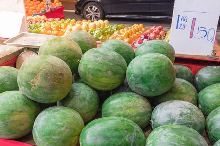 Fresh harvested watermelons with price tag label at fruit stand in Geylang, Singaporeの写真素材