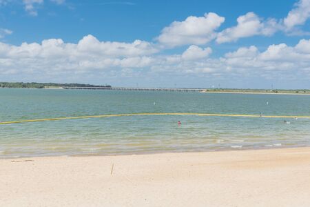 White sandy shore and fresh water impoundment in Joe Pool, Lynn Creek Park outside Dallas, Texasの写真素材