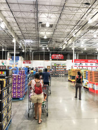 Crowded people waiting in line for checkout at Costco warehouse with social distancing near Dallas, Texasのeditorial素材