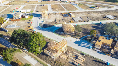 Multiple wooden houses under construction at master planned community suburbs Dallas, Texas, America. Typical two story single family homes on slab foundationの写真素材