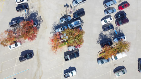 Grocery store parking lot with shopping carts return area surrounded by colorful autumn leaves in suburban Dallas, Texas, Americaの写真素材