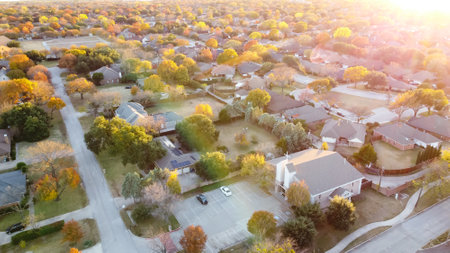 Aerial view suburban church near residential neighborhood at sunset with colorful fall foliage near Dallas, Texas, Americaの写真素材