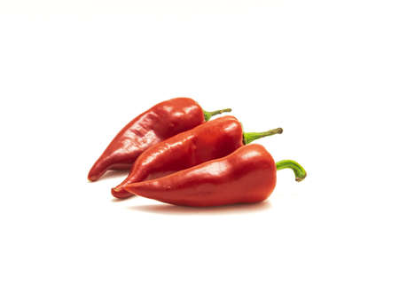 Three ripe Fresno chile or Fresno chili pepper fruits isolated on white background. Capsicum annuum similar with jalapeno pepper from Mexico.の写真素材