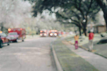 Blurred image fire trucks with flashing light on residential streets in suburban Dallas, Texas,...