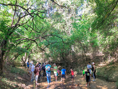 COPPELL, TX, USA-OCT 9, 2021: Diverse parents and kids attending the Geology and Fossils program with geologist along the creek in nature settings. Friendly outdoor learning experience eventのeditorial素材
