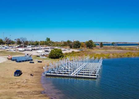 Top view working lakeside construction site with galvanized steel dock systems and building...
