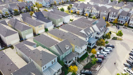 Aerial view close-up roof shingles of new development townhouse near historic Old Town Coppell, Texas, USA. Upscale cottage style homes in suburbs Dallas covered porch patio, no backyardの写真素材