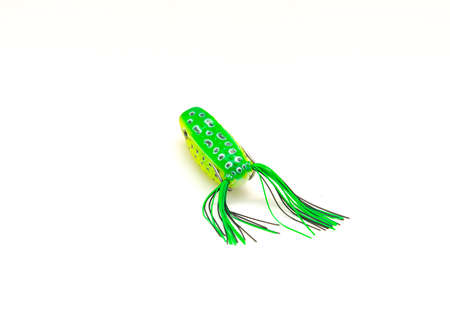 Top view close-up topwater frog lure bait isolated on white background. Surface poppers frog shape and realistic decoration features frog belly with chines for freshwater bass fishing, double hooksの写真素材