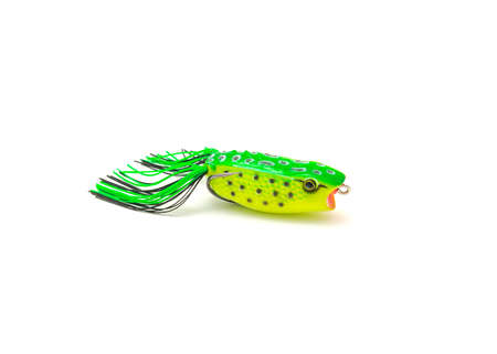Side view close-up topwater frog lure bait isolated on white background. Surface poppers frog shape and realistic decoration features frog belly with chines for freshwater bass fishing double hooksの写真素材