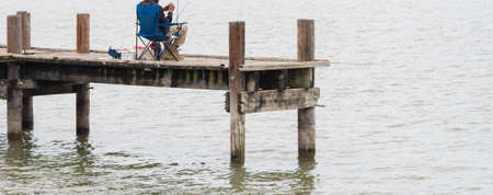 Close-up rear view Black fisherman tie fishing knot on folding chair at fishing pier at Lake Ray Hubbard near Dallas, Texas, Americaの写真素材