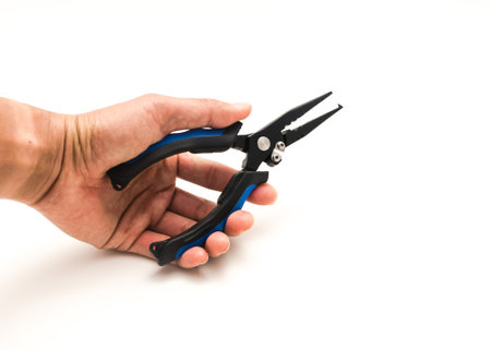 Asian fisherman hand holding fishing pliers in open position isolated on white background. Stainless...