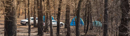 Panorama view row of tents and cars at camping site in national park of Oklahoma, America. Outdoor, explorer and recreational activities in a sunny wintertime day.の写真素材