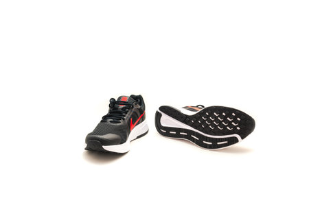 DALLAS, TX, USA-APR 27, 2022: Brand new pair of black and white with red logo of trendy Nike running shoes for men isolated on white background.のeditorial素材