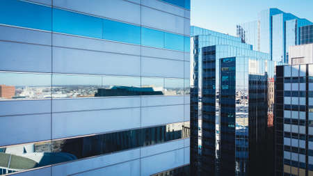 Toned photo aerial close up view of skyscrapers office building with glass windows reflection in downtown Oklahoma City. High rise towers modern architecture background.のeditorial素材