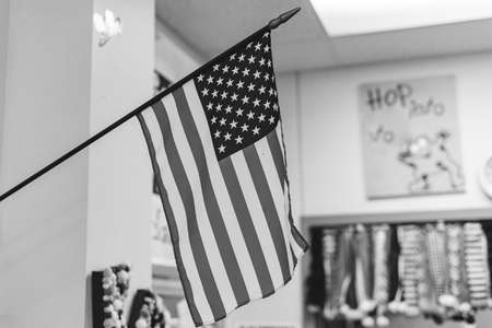 Black and white photo of proudly display of American flag in wall mouth flagpole in kindergarten...