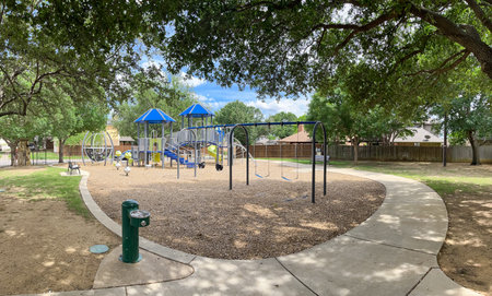 Drinking water fountain in public community park playground structure wood chips mulch, concrete...
