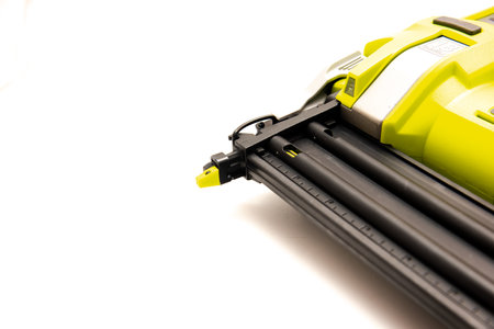 Tip of the brad nailer a power tool that drive a small finish-type nail or brad from a built-in...