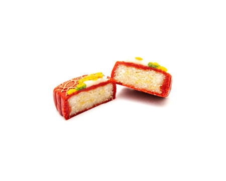 Two slice cuts of Vietnamese mooncakes with trending 3D floating flower decoration isolated white background, mid-autumn festival celebration. Bakery dessert from bean, nut, rice, black sesameの写真素材