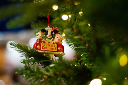Farm animals goat pig sheep red truck ornament with Merry Christmas letters hanging on artificial Christmas tree at Xmas store in Dallas, Texas, USA, soft illuminated bokeh background. Holiday displayの写真素材