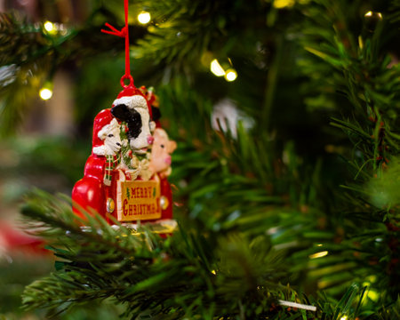 Farm animals goat pig sheep red truck ornament with Merry Christmas letters hanging on artificial Christmas tree at Xmas store in Dallas, Texas, USA, soft illuminated bokeh background. Holiday displayの写真素材