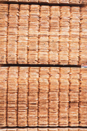 Full background large stack of wooden cedar pickets pallet with polyester strapping at hardware home...