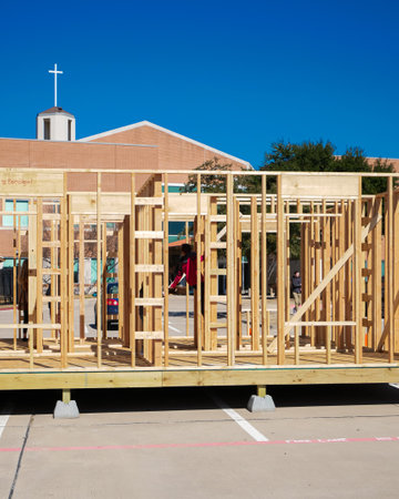 Church ministry project building mobile home, residential manufactured house under construction, wooden prefab house timber framing at parking lot, suburbs Dallas, Texas, community donation. USAの写真素材