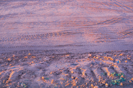 Groundworks with heavy truck tire tread traces at construction site during sunset, prepare the ground foundations, high quality industrial background, Oklahoma. USAの写真素材