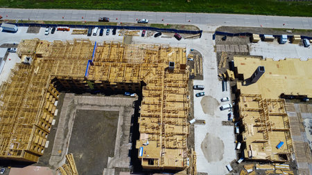 Courtyard open typology multi-story apartment complex under construction, wooden framework, slab...