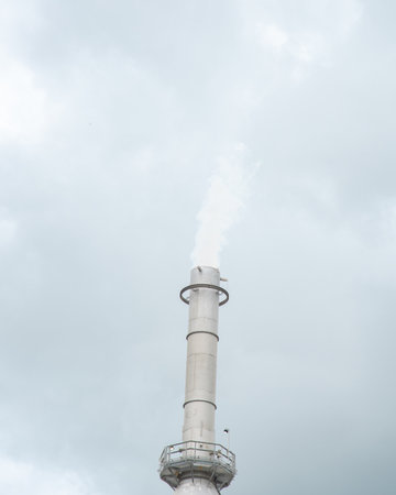 Close-up gas flare or flare stack with clouds of exhaust fumes under overcast sky from crude oil refinery plant in San Antonio, Texas, major source of air pollutants refined petroleum products. USAの写真素材