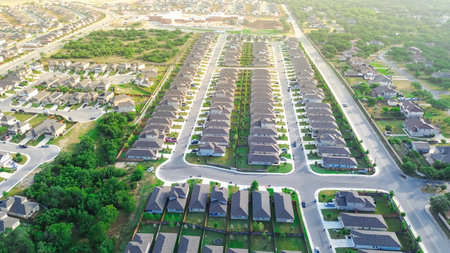 Urban sprawl suburban neighborhood subdivision long row of new development two story houses quite...