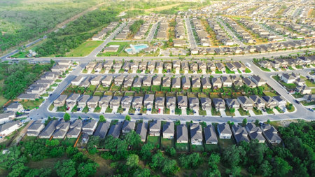 Urban sprawl suburban neighborhood subdivision long row of new development two story houses quite...