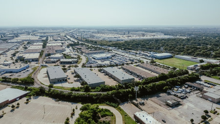 Freight railroad along East Division Street in industrial manufacturing zoning South of Arlington, Texas, dense of warehouse space, fulfilment center in supply chain hub logistic gateway, aerial. USAの写真素材