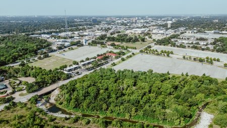 Urban forest lush green park near industrial manufacturing zone South of Arlington, Texas, warehouse, fulfilment center, rapidly developing supply chain hub logistic, established business, aerial. USAの写真素材