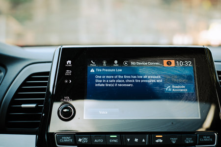 Indicator lights and message on LED display screen for tire pressure low indicator of modern car...