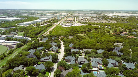 Upscale residential neighborhood lush greenery area with city water tower, dense of warehouse...