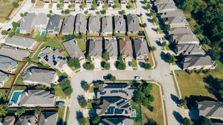 Solar panel roofing on modern corner houses at new construction residential neighborhood in Argyle, Denton County, Texas, upscale two-story suburban home swimming pool, well maintained landscape. USAの写真素材